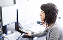 Woman working at a desktop computer