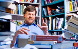 Man at desk with books