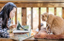 Girl reading with a cat