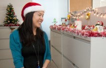 Woman looking at holiday decorations on a cubicle