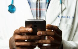 Doctor holding cellphone