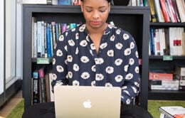 Woman working on laptop in home office