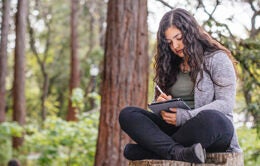 Woman writing in a journal