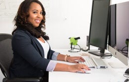 Young woman sitting at computer