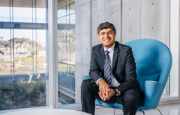 Man sitting on blue chair