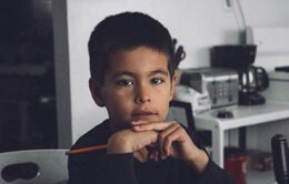 Boy sitting with pencil