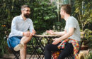 Two men talking at outdoor table