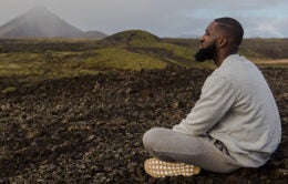 Seated man meditating outside