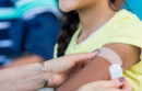 Person receiving bandaid after vaccine