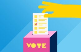 Hand placing ballot in box