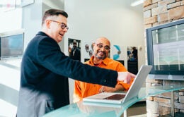 Two men working at computer