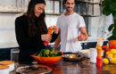 Couple cooking peppers in a red bowl