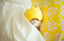 Cat sleeping wearing yellow face mask
