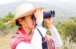 Woman looking through binoculars
