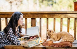 Woman reading with cat