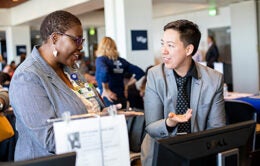 CJ Frosch, right, operations manager and executive assistant in the department of Finance, introduces Karen Brent, MA, communications analyst in Medical Education, to learning and development opportunities at the annual Staff Resource Day, in the Millberry Conference Center, at the Parnassus campus.