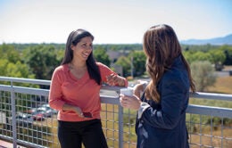 Two coworkers talking on a patio