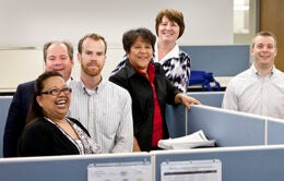 UCOP colleagues around a cubicle