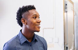 Young man looking in the distance and smiling