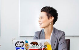 Woman with short hair working on laptop computer