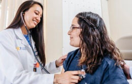 Doctor checking patient's heartbeat
