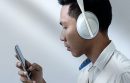 Man looking at phone while wearing headphones