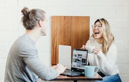 Man and woman having conversation over coffee