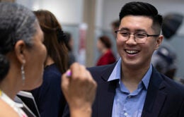 Tina Hinnant, left, chats with University of California graduate Joseph Chun at an alumni job fair at the South San Francisco Conference Center, Thursday, May 2, 2019 in South San Francisco, Calif. (Photo by D. Ross Cameron)
