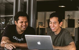 Men working at laptop computer