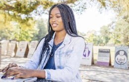 Student working on laptop on campus