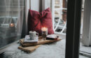 Cozy windowseat with pillow, candle and hot cocoa