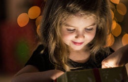 Young girl opening present