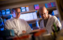Rob Knight, left, UC San Diego professor of pediatrics and computer science and engineering, and postdoctoral researcher Daniel McDonald, right, discuss data from The American Gut Project. Knight is the only person out of the entire list of 6,602 people to be highly cited in four or more disciplines.