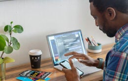 Man working at home on laptop and phone