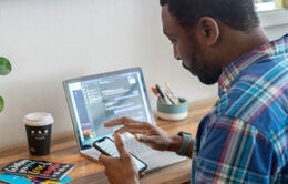 Man working remotely on laptop computer