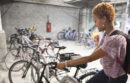 Woman parking bike in Oakland garage