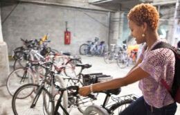 Woman parking bike in Oakland garage