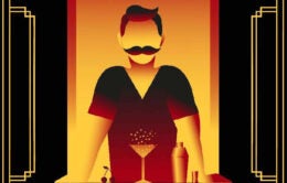 Bartender standing with martini glass and shaker