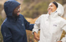 Two people in raincoats laughing