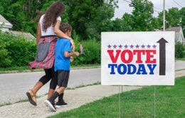 Woman and child walking to voting location