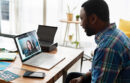 man smiling on a zoom call with a woman