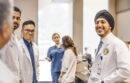 Diverse group of UC medical students talking in a lab