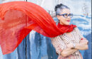 Woman wearing billowing red scarf