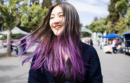 Woman flipping her purple hair back
