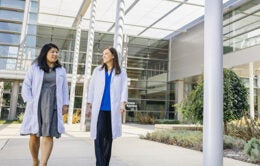 UC Health physicians walking outdoors on campus