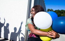Woman holding balloons