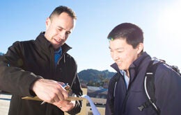 Men looking at docs on a clipboard