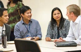 Colleagues chatting together around a table