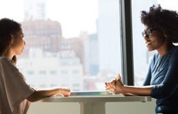 Women having a conversation over a table