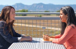 colleagues having a conversation outside on a table